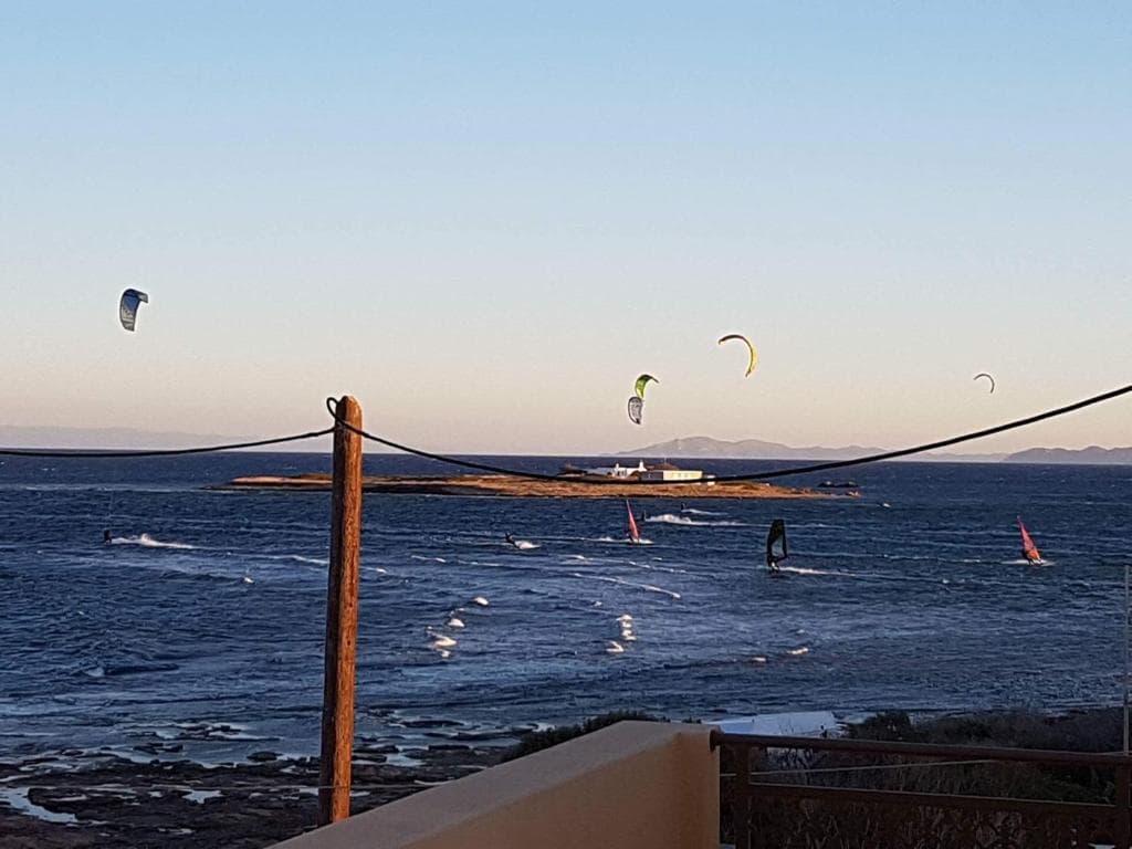 Kitesurfers at sunset off the beach in Artemida, Attica